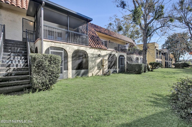 rear view of house with a yard