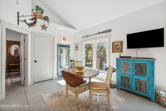 dining area featuring vaulted ceiling