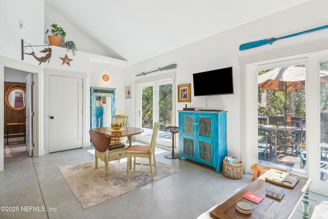 dining room featuring high vaulted ceiling and french doors