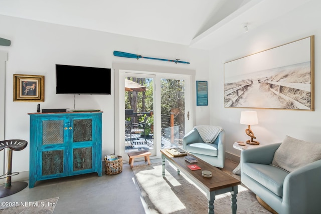 living room with concrete flooring and lofted ceiling