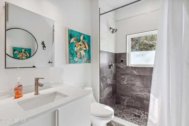 bathroom featuring a shower with shower curtain, vanity, and toilet