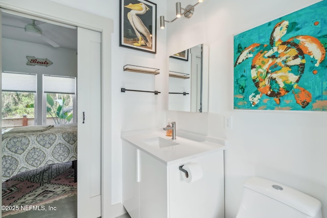 bathroom featuring ceiling fan, vanity, and toilet