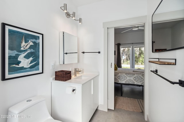 bathroom with ceiling fan, vanity, and toilet