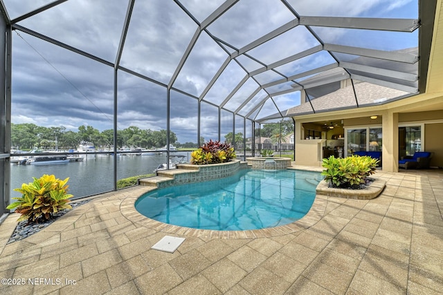 view of swimming pool with glass enclosure, a patio area, an in ground hot tub, and a water view