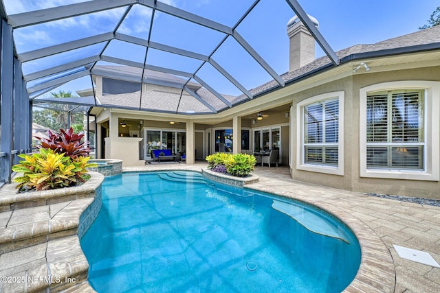 view of pool featuring ceiling fan, a patio area, an in ground hot tub, and a lanai