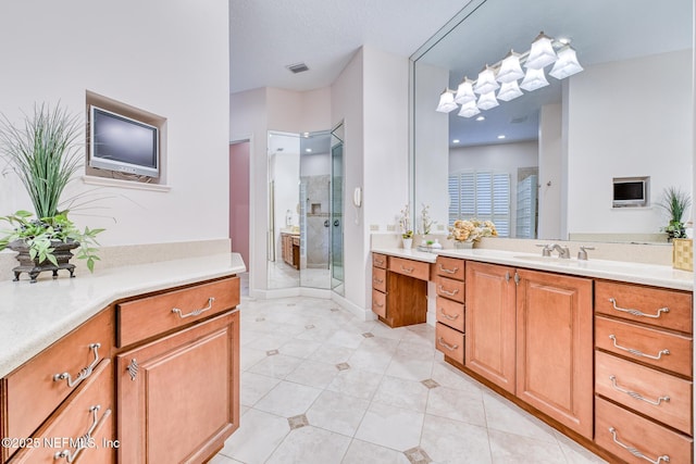 bathroom with tile patterned flooring, a shower with shower door, and vanity