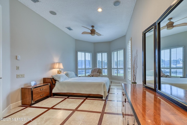 tiled bedroom with a textured ceiling, ceiling fan, and access to outside