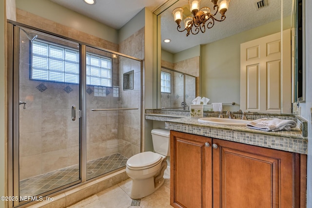 bathroom featuring toilet, tile patterned floors, walk in shower, a chandelier, and vanity