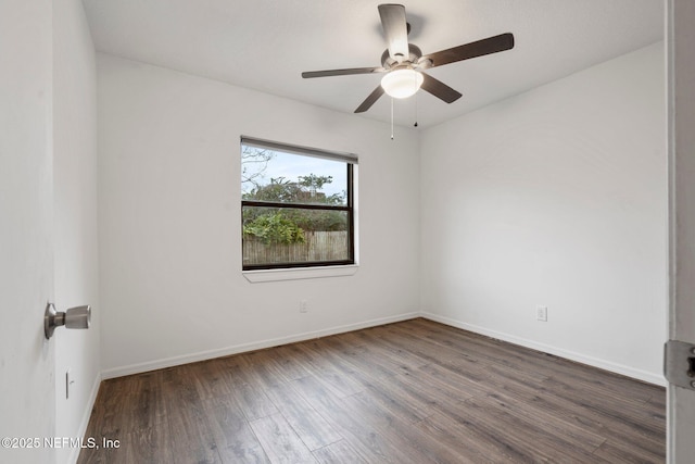 empty room featuring ceiling fan and dark wood-type flooring