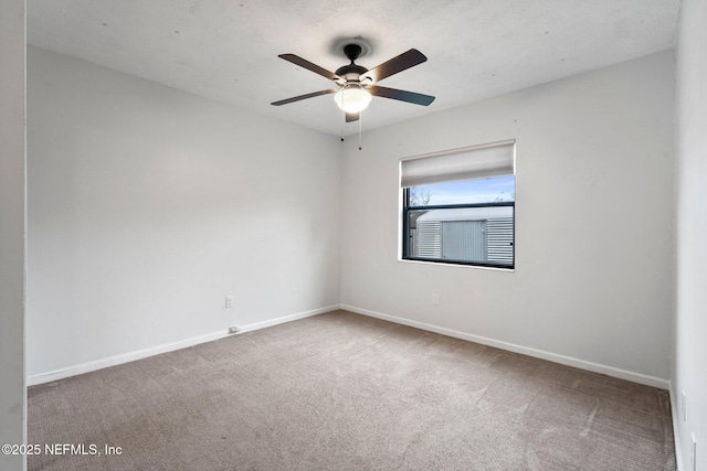 empty room with carpet floors and ceiling fan