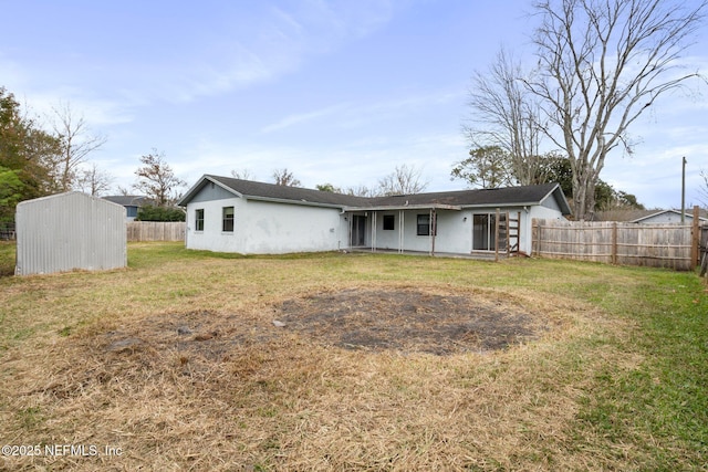 back of property featuring a lawn