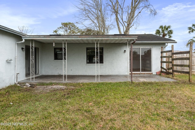 rear view of house featuring a patio area and a yard