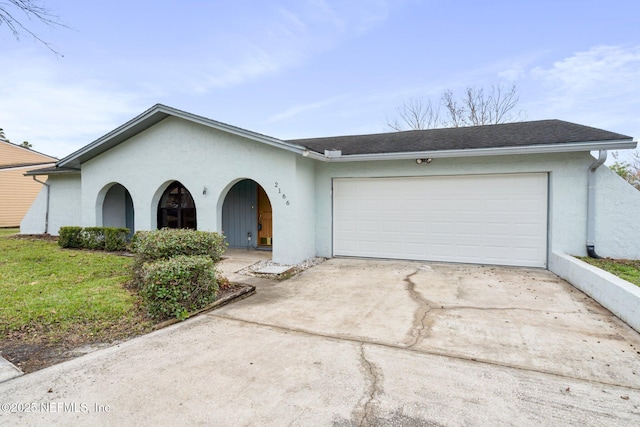 single story home with a front yard and a garage