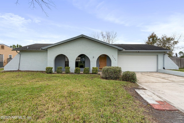 single story home featuring a front yard and a garage