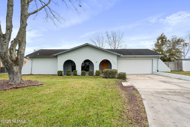 ranch-style house featuring a front yard, a garage, and central AC unit