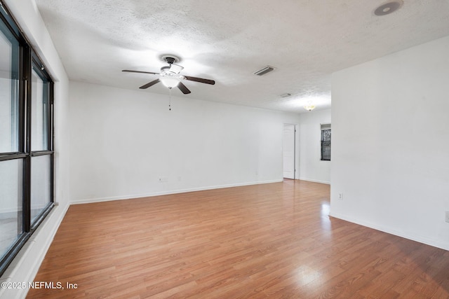 unfurnished room featuring a textured ceiling, ceiling fan, and light hardwood / wood-style floors