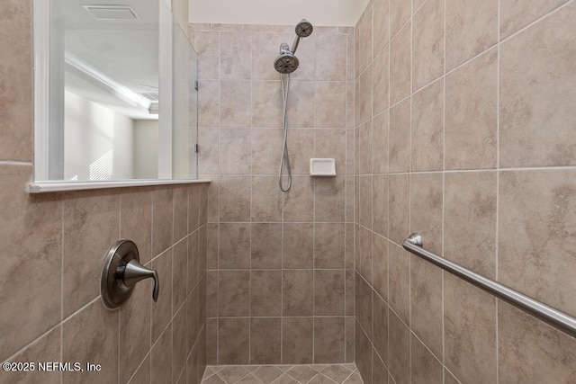 bathroom with a tile shower