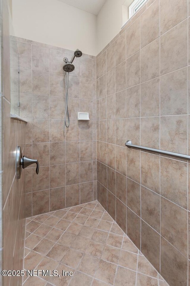 bathroom with tiled shower