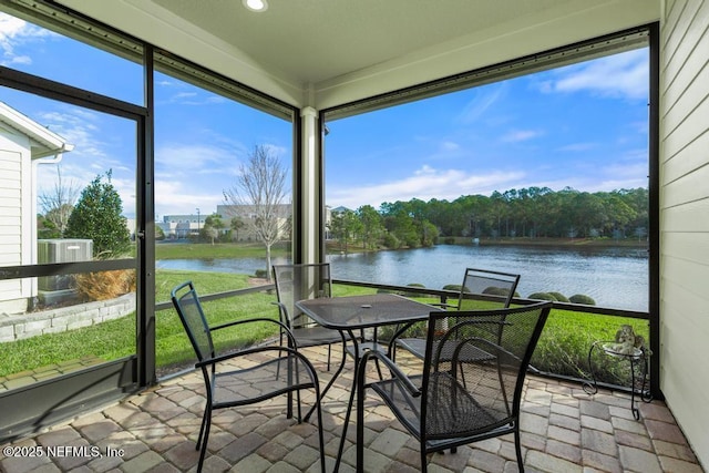 sunroom / solarium featuring a water view