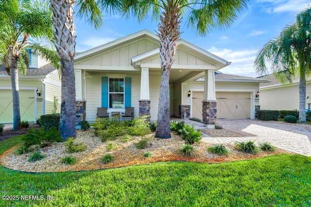 craftsman-style home with a front yard and a garage