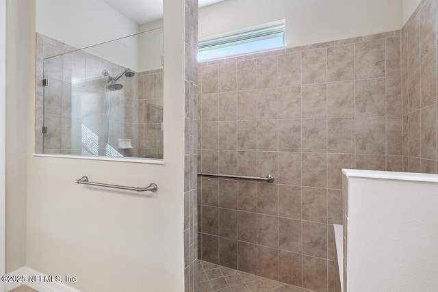 bathroom with tiled shower