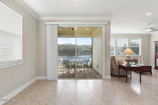 doorway with ceiling fan, a water view, light tile patterned floors, and ornamental molding