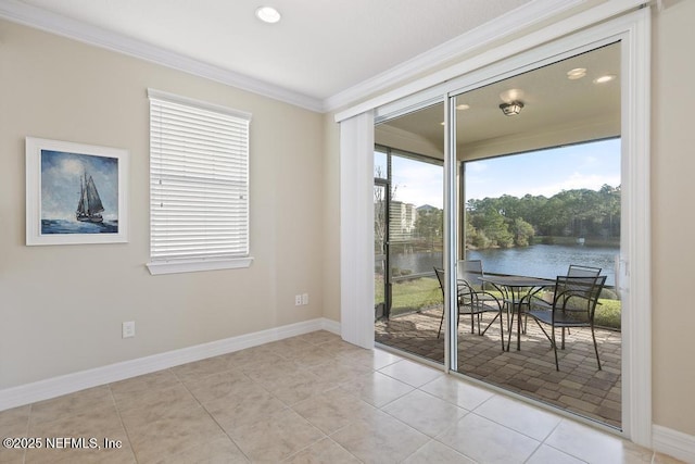 entryway featuring plenty of natural light, a water view, light tile patterned flooring, and ornamental molding