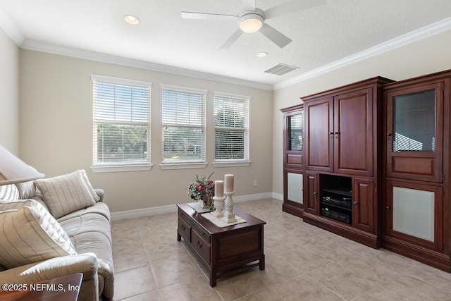 tiled living room with ceiling fan, a healthy amount of sunlight, and ornamental molding