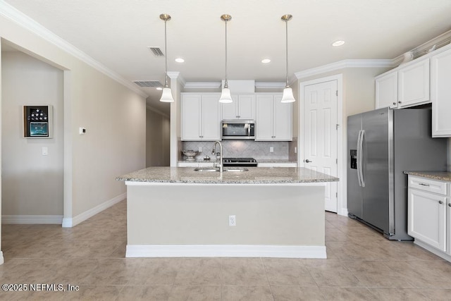 kitchen with white cabinets, an island with sink, decorative light fixtures, light stone counters, and stainless steel appliances