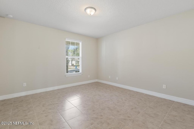 unfurnished room featuring light tile patterned flooring