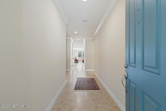 corridor with light tile patterned floors and ornamental molding