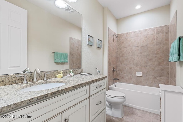 full bathroom with tile patterned floors, tiled shower / bath combo, toilet, and vanity