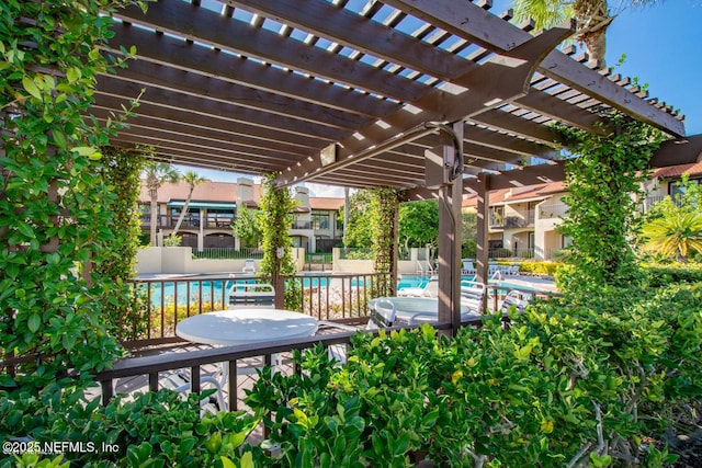 view of patio / terrace with a community pool and a pergola