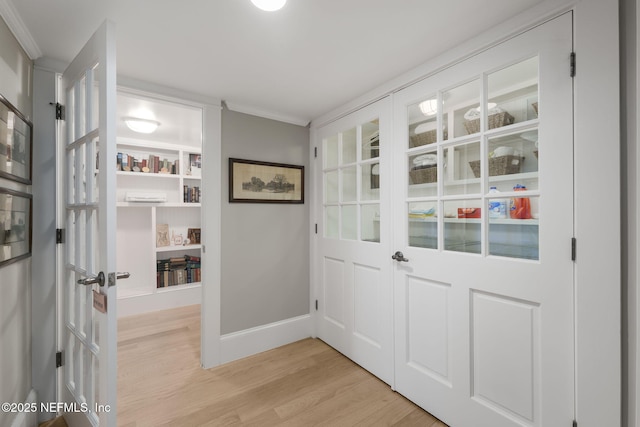 doorway featuring light wood-type flooring and ornamental molding