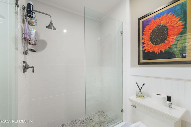 bathroom featuring tiled shower and ornamental molding