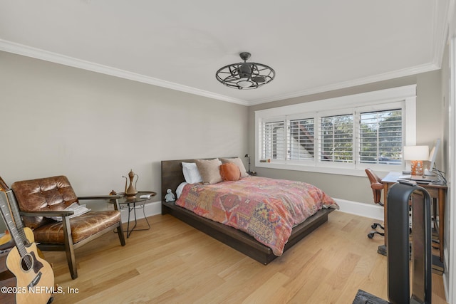 bedroom featuring ornamental molding and light hardwood / wood-style flooring