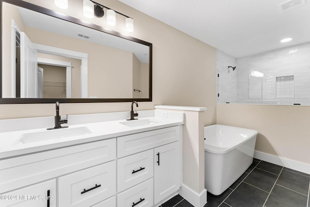 bathroom with tile patterned floors, separate shower and tub, and vanity