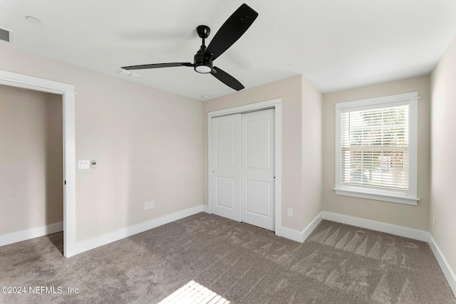 unfurnished bedroom with a closet, ceiling fan, and light colored carpet