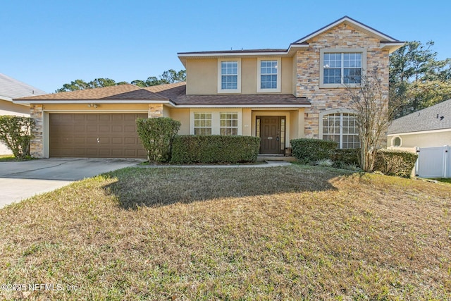 view of property with a front lawn and a garage