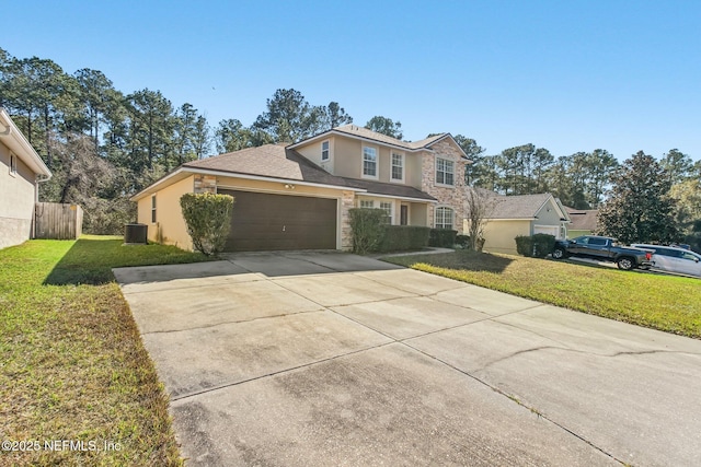 view of front property with central AC unit, a front yard, and a garage