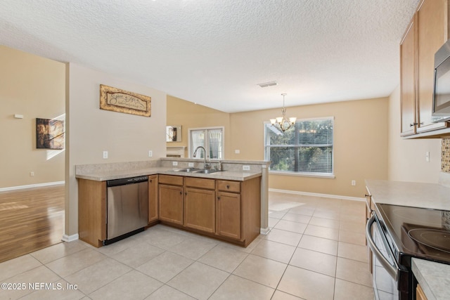 kitchen featuring sink, stainless steel appliances, kitchen peninsula, pendant lighting, and light tile patterned floors