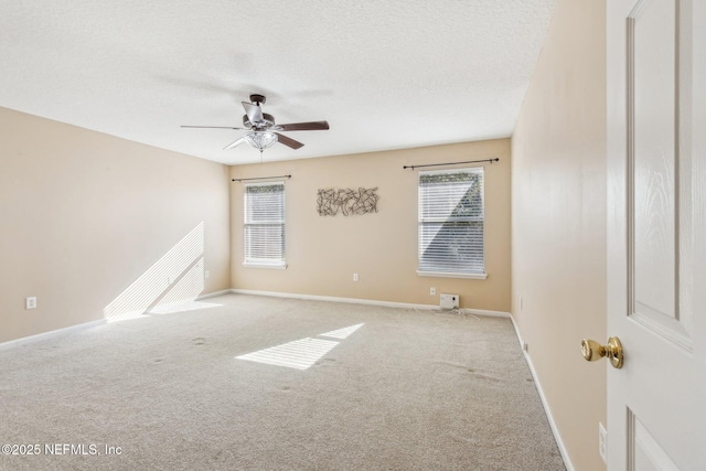 carpeted empty room featuring ceiling fan and a textured ceiling