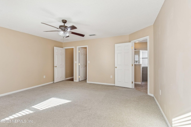 unfurnished bedroom featuring ceiling fan and light carpet