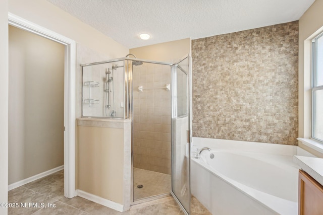 bathroom featuring vanity, a textured ceiling, independent shower and bath, and tile patterned flooring