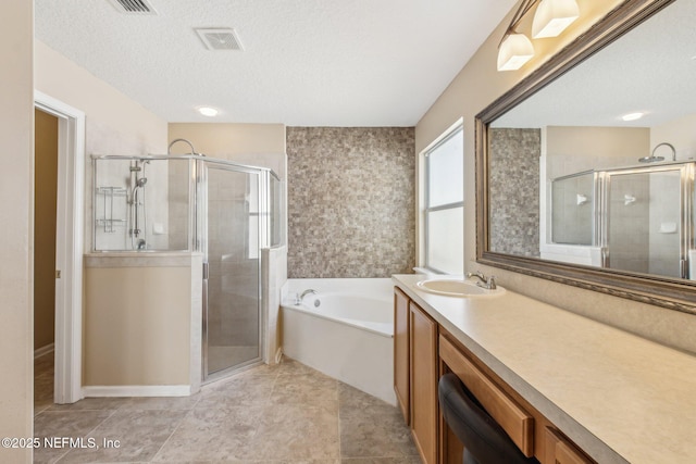 bathroom with shower with separate bathtub, vanity, and a textured ceiling