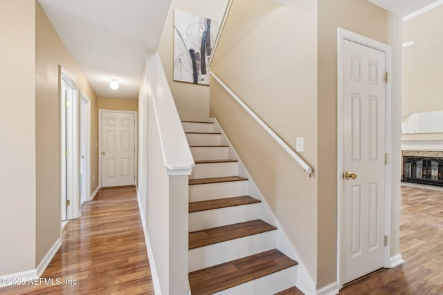 stairs featuring hardwood / wood-style floors