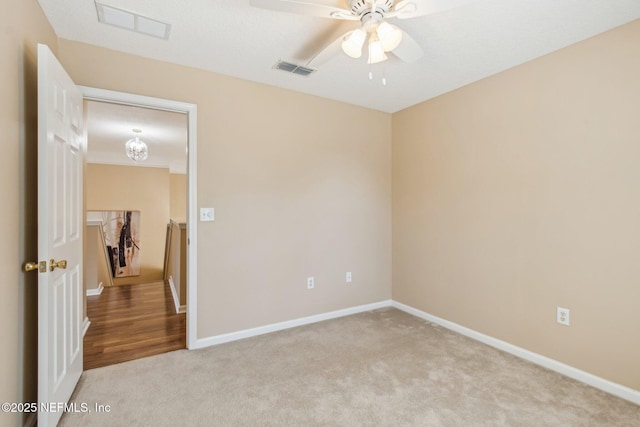 carpeted spare room with ceiling fan