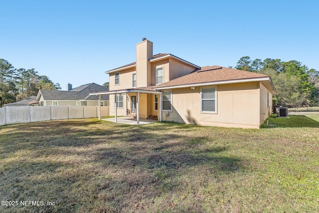 back of house with a patio area, a yard, and central AC unit