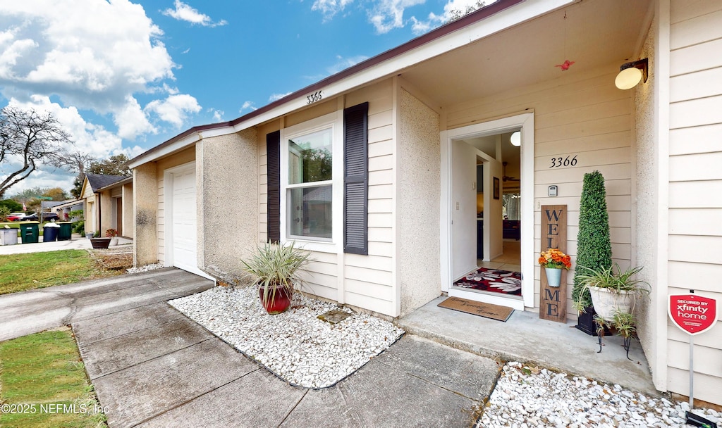 doorway to property with a garage