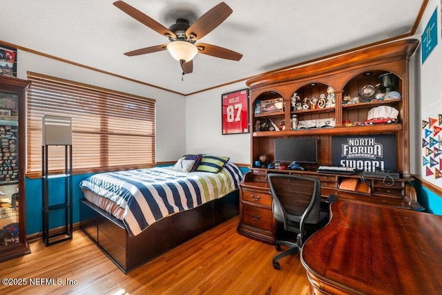 bedroom featuring ceiling fan, light hardwood / wood-style floors, and ornamental molding